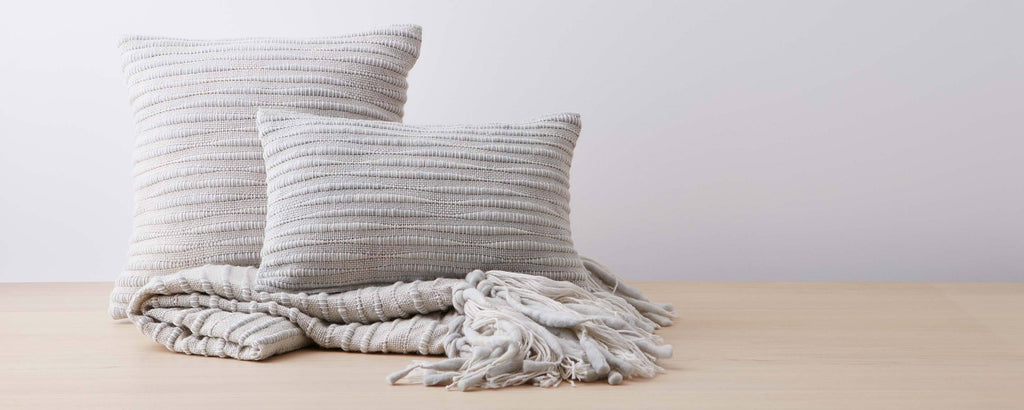 light gray caterpillar pillows and throw
