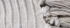 light gray caterpillar pillows and throw