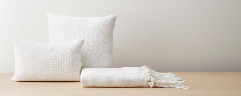 white cotton pillows and throw