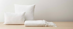 white cotton pillows and throw