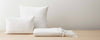white cotton pillows and throw